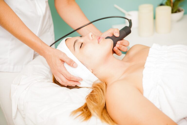 A handheld treatment device being used on a reclining client
