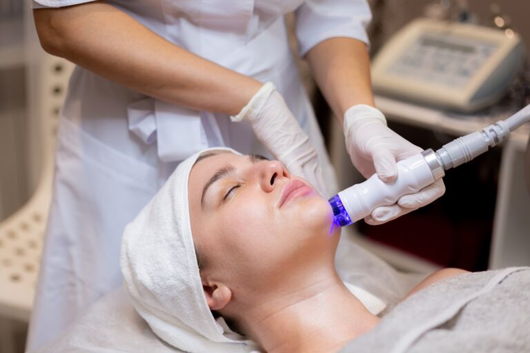 A practitioner using a handheld device on a reclining client