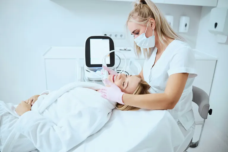A practitioner and a patient talking in a treatment room during a consultation
