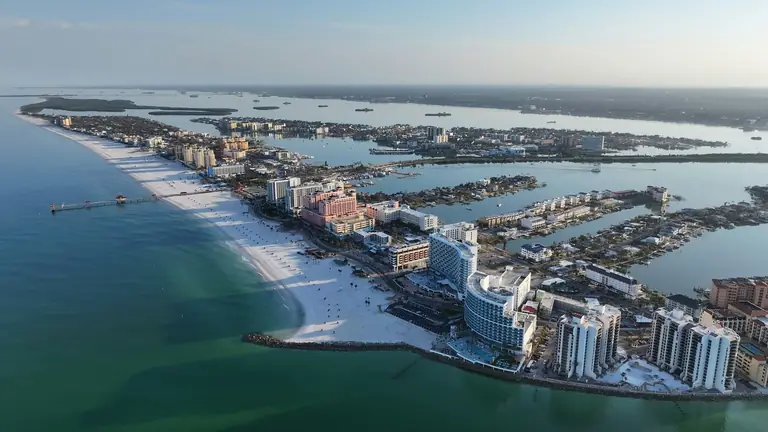 Clearwater Beach, Florida from the air, the barrier island with its white sand, fishing pier and beachfront hotels beside the intracoastal waterway